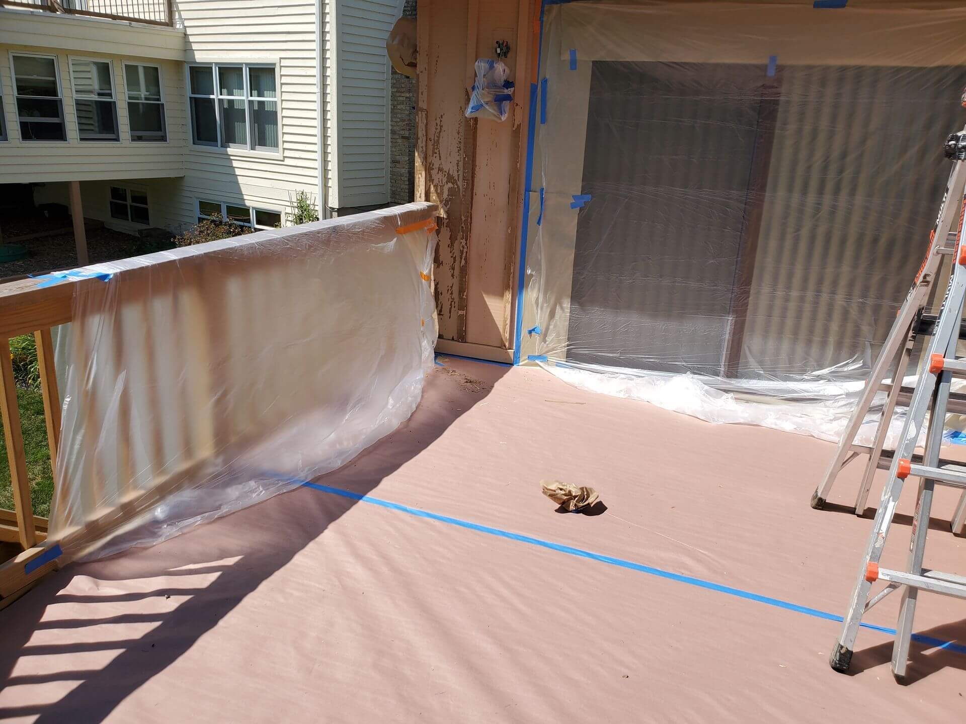 Ladder on deck with taped plastic sheets